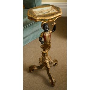 A Venetian blackamoor stand, 19th century, the shaped top…