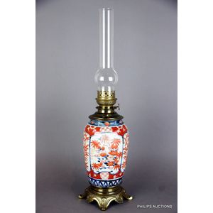 An antique fuel lamp with an Imari base, 19th century, the…