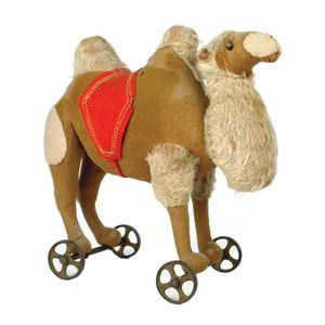 A c.1908 Steiff camel on wheels toy, the brown felt body with…