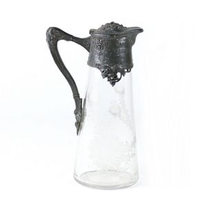 An Art Nouveau pewter and glass claret jug, the jug with etched…