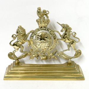 A vintage brass door stop, in the form of the British…