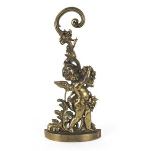An English cast brass door stop in the form of a cherub, 19th…