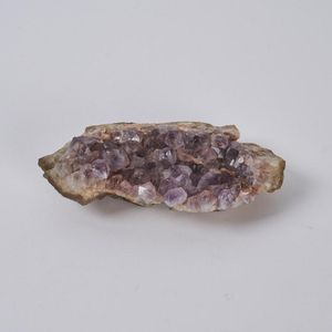 An amethyst Druze, a dense coating of amethyst crystals on a…