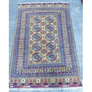 An unusually toned Bukhara rug, in burnt umber and red tones,…