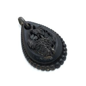 An antique Vulcanite pendant, drop shape applied with bunch of&hellip;