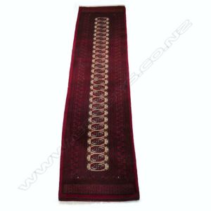 A hand knotted Bokhara runner, the field decorated with…