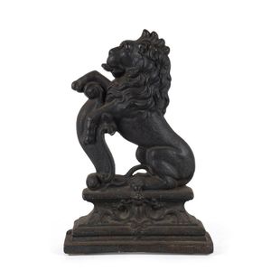 An English cast iron door stop in the form of a rampant lion,…