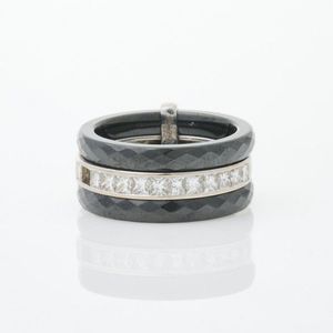 A modern three band ring by Guy Laroche, consisting of a white…
