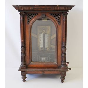 Upright penny Polyphon. Arched and fretted door in column…