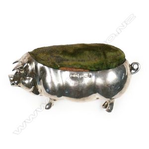 An Edwardian silver pin cushion, in the form of a pig, with…
