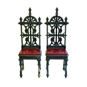 A pair of Coalbrookdale cast iron hall chairs designed by…