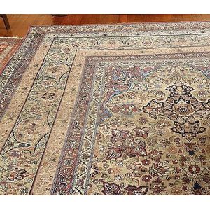 An antique Bokhara carpet with a foliate field on a cream…