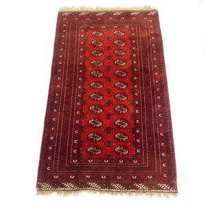 A hand knotted Bokhara rug the field decorated with geometric…