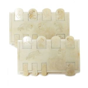 A pair of Japanese ivory whist counters, the top decorated with…