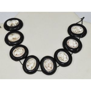 A jet necklace, inset with cameos depicting various faces.