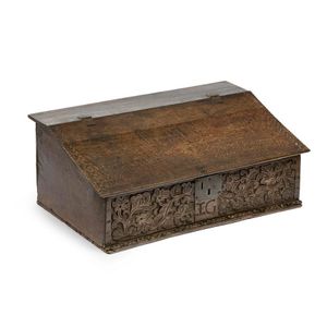 A late 17th century carved oak bible box, the sloping hinged…