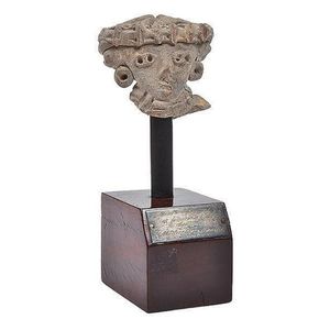 A Mexican clay head in the form of the double Eyed goddess,…