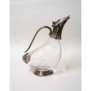 A silver plate and glass bodied wine decanter, stylised bird…