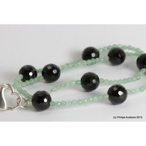 A strand of faceted onyx and Aventurine quartz beads. A strand…