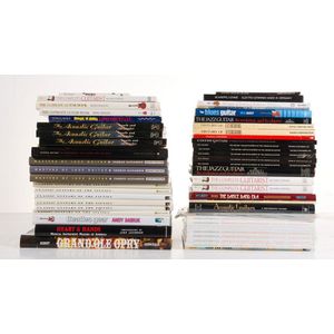 A collection of guitar reference books, including multiple…