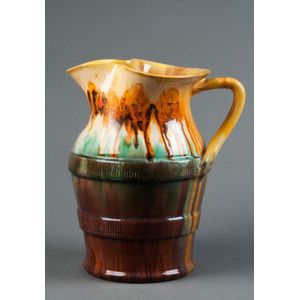 Remued: pottery jug with branch handle; body decorated with two…