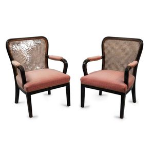 A pair of Austrian Art Deco armchairs, ebonised frames with…