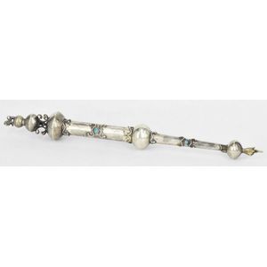 A silver torah yad, with lion finial, inset with blue paste.…