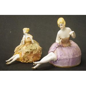 Two good German pin-cushion half dolls, both with raised hands.