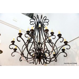 An eighteen branch wrought iron chandelier, a provincial style…