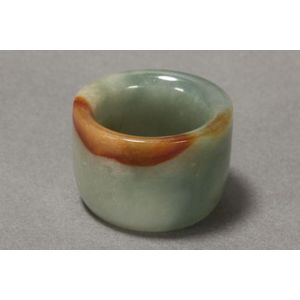 Chinese jade archers ring, of rounded form, in tones of green&hellip;