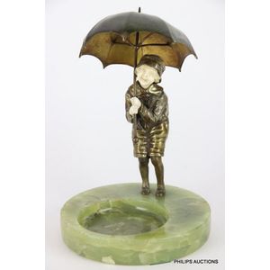 A gilt bronze and ivory figure of a girl with a large umbrella,…