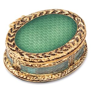 A Faberge enamelled trinket box, decorative gold tone oval box…