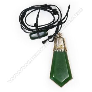A colonial 9ct gold and pounamu pendant, gold frame with…