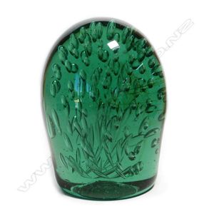 A Victorian green glass 'dump' paperweight, internally with…
