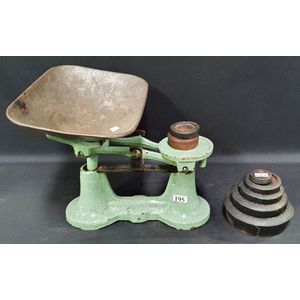 A set of green enamel Metters Sydney scales, with seven weights,…