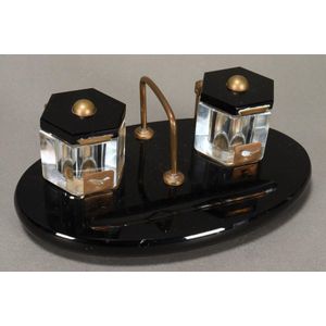 Black Art Deco desk set, of oval form, with two facetted…