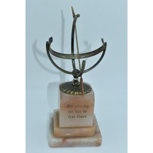 Celestial brass sun dial on a marble base, height 24 cm