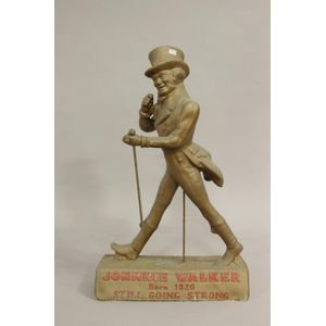 A vintage cast Johnnie Walker advertising figure. Height 73 cm