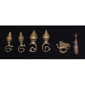 Six heavy brass Dayak ear ornaments, 9 -11 cm