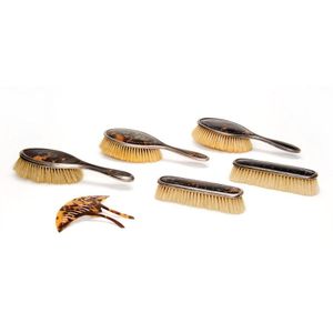 A collection of tortoise shell brushes and a hair implements,…