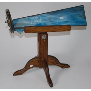 Contemporary stained glass kaleidoscope on a timber stand,…