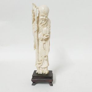 A Chinese ivory figure of Shou Lao, the god stands holding a&hellip;