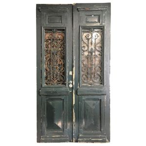 A pair of green painted oak entrance doors with wrought iron…