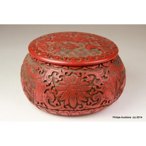 A Chinese lidded cinnabar box. Modern era, of compressed ovoid…