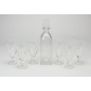 An Orrefors decanter and six waterford champagne flutes.…