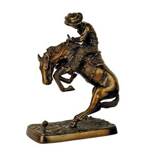 A Remington style bronze sculpture of a rearing horse and…