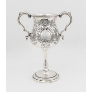A two handled silver plate trophy goblet and a shell form dish,…