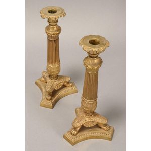 Pair of French Empire style gilt candlesticks, the fluted…