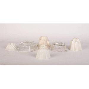A collection of six ceramic and glass jelly moulds, 19th…