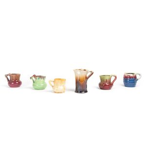 Remued: group of six pottery jugs with branch handles, circa…